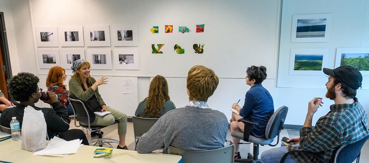 Students looking at artwork in a classroom with instructor