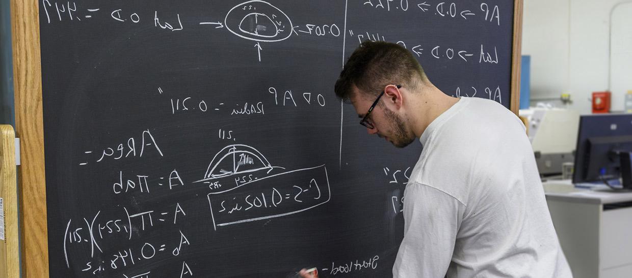 Student working on problem at chalkboard