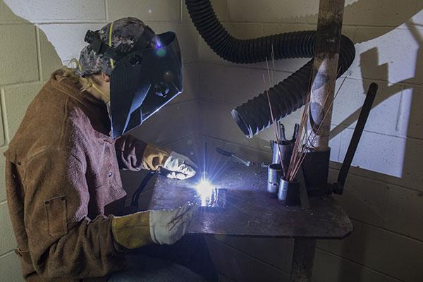 Student using welding equipment